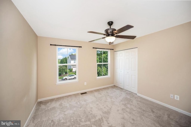  - unfurnished bedroom with carpet floors, a closet, and ceiling fan