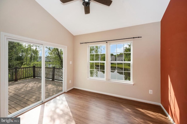  - spare room with wood finished floors, ceiling fan, a water view, and high vaulted ceiling