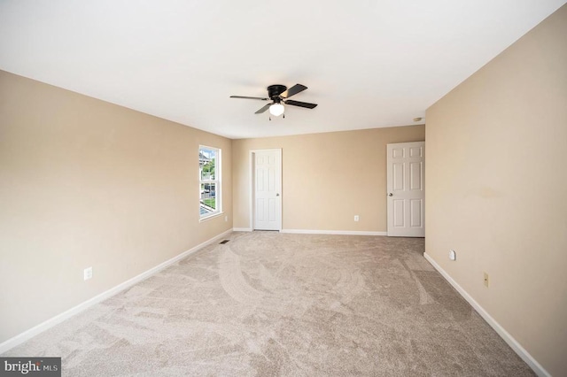  - spare room with ceiling fan and light colored carpet