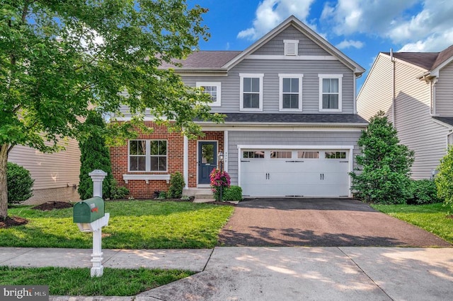  - view of front facade featuring asphalt driveway, a garage, a front yard, and brick siding
