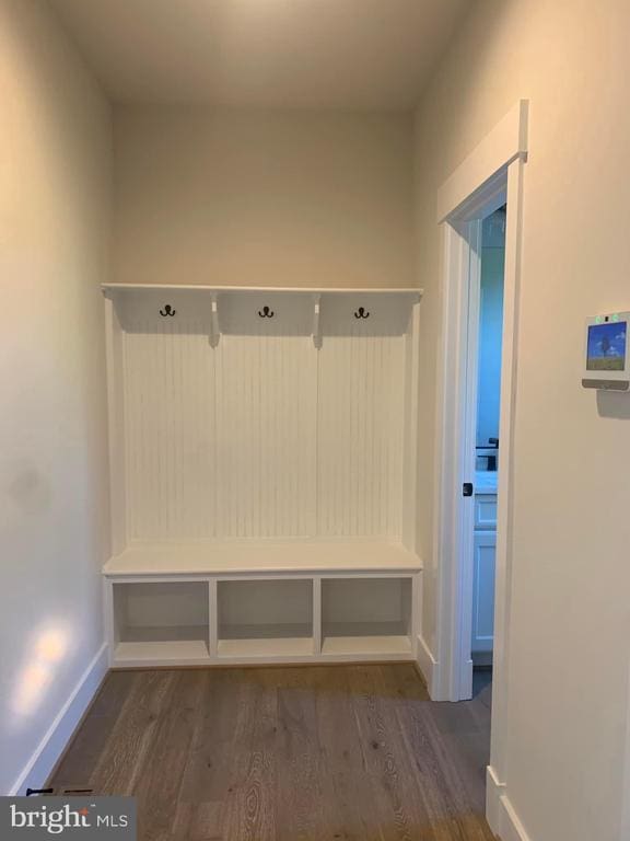 mudroom featuring wood finished floors and baseboards