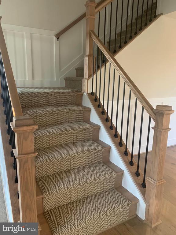 staircase featuring wood finished floors