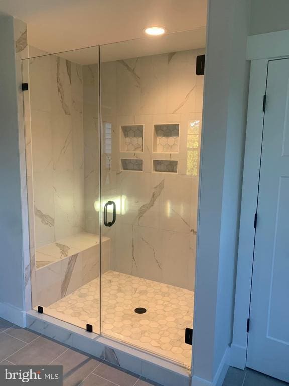  - bathroom featuring a marble finish shower, tile patterned floors, and recessed lighting