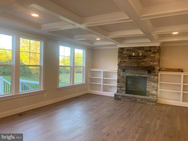unfurnished living room featuring wood finished floors, a fireplace, baseboards, coffered ceiling, and beamed ceiling