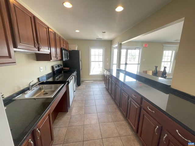 1520 Villa Ter Unit F, Charlottesville, VA 22903 - kitchen with recessed lighting, a wealth of natural light, a sink, stainless steel microwave, and electric range