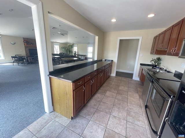 1520 Villa Ter Unit F, Charlottesville, VA 22903 - kitchen featuring light tile patterned flooring, ceiling fan, open floor plan, dark countertops, and appliances with stainless steel finishes