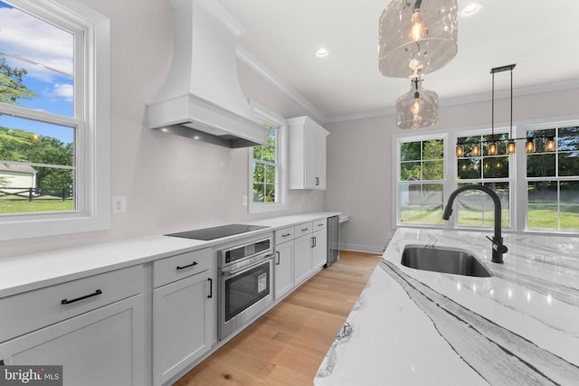 Richards Ferry Rd, Richardsville, VA 22736 - kitchen featuring oven, custom range hood, black electric stovetop, ornamental molding, and hanging light fixtures