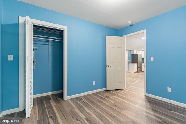 236 Laurel Dr, Madison, VA 22727 - unfurnished bedroom featuring freestanding refrigerator, wood finished floors, and a closet