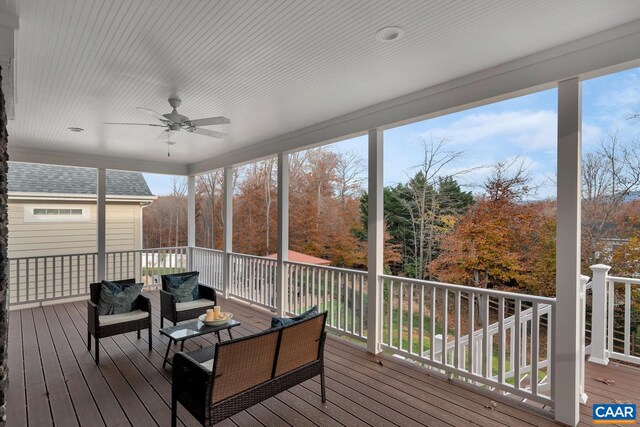 sunroom featuring a ceiling fan and an outdoor hangout area
