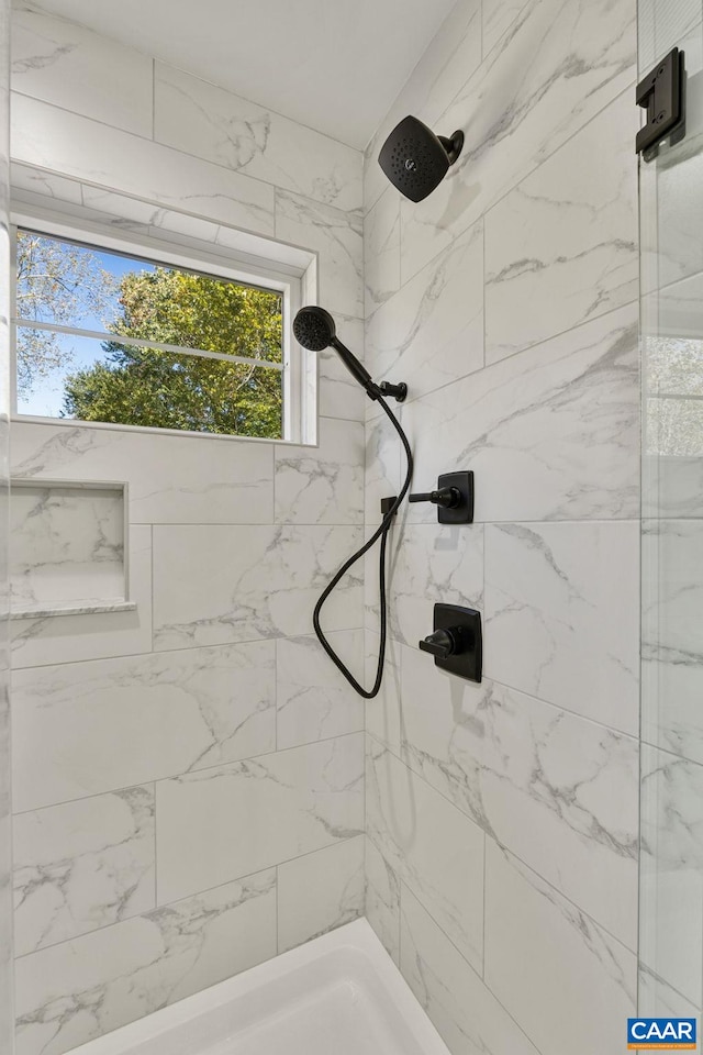 bathroom with a tile shower