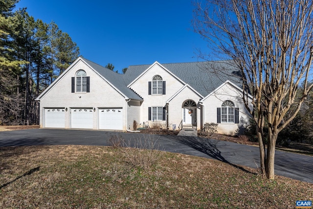 278 Foxmoor Rd, Troy, VA 22974 - traditional home featuring an attached garage, asphalt driveway, and brick siding