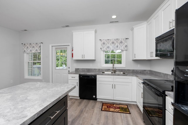 59,61,61A,63,63 Woodlee Road, Staunton, VA 24401 - kitchen with black appliances, light wood-style floors, white cabinets, recessed lighting, and light countertops