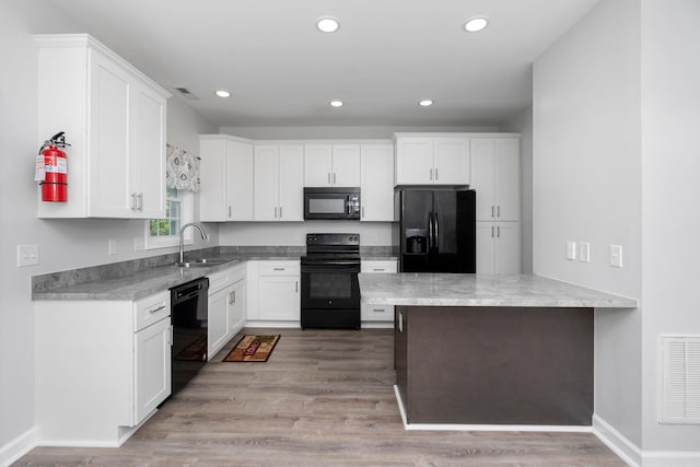 59,61,61A,63,63 Woodlee Road, Staunton, VA 24401 - kitchen with black appliances, white cabinets, light wood finished floors, recessed lighting, and a peninsula