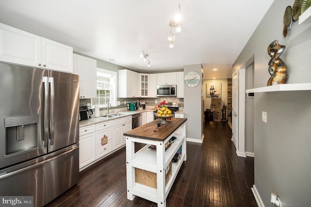 11714 Falcon Ridge Dr, Fredericksburg, VA 22407 - kitchen with stainless steel appliances, a sink, butcher block counters, glass insert cabinets, and tasteful backsplash