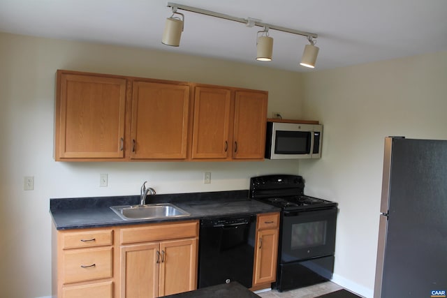 1508 Villa Ter Unit F, Charlottesville, VA 22903 - kitchen with baseboards, a sink, rail lighting, black appliances, and dark countertops