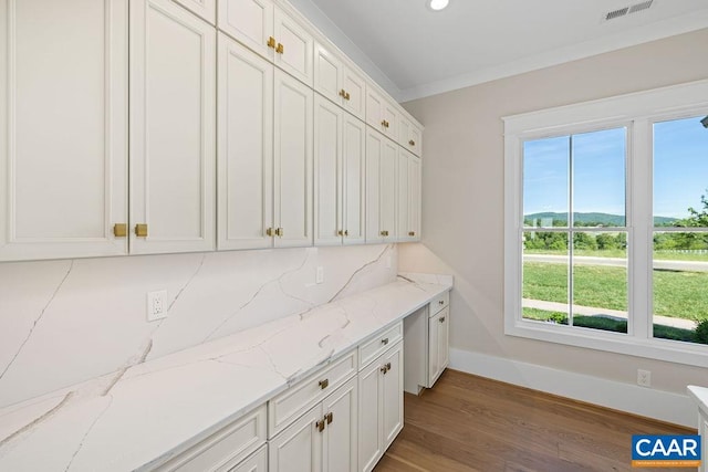 100 Stable Ln, Lynchburg, VA 24503 - kitchen with healthy amount of natural light, white cabinetry, wood finished floors, and ornamental molding