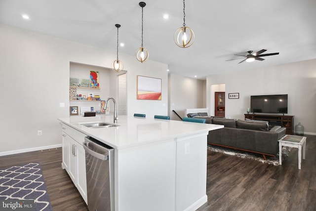 kitchen featuring a sink, stainless steel dishwasher, dark wood-style floors, light countertops, and white cabinets