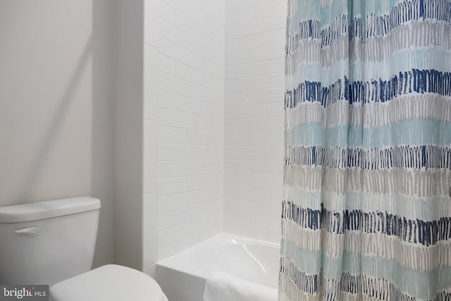 bathroom with toilet and shower / tub combo with curtain