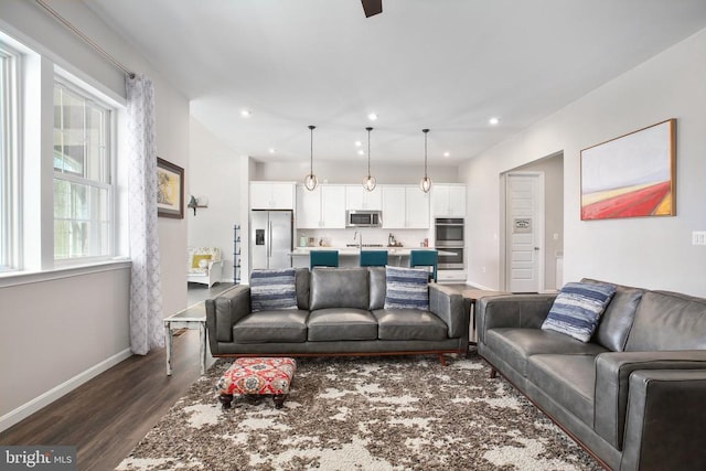 living room featuring dark wood-style floors, baseboards, and recessed lighting