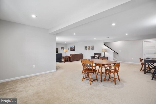 carpeted dining area featuring baseboards, stairs, and recessed lighting