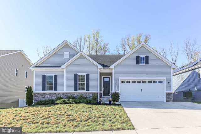 view of front of home with stone siding, driveway, a garage, and a front yard