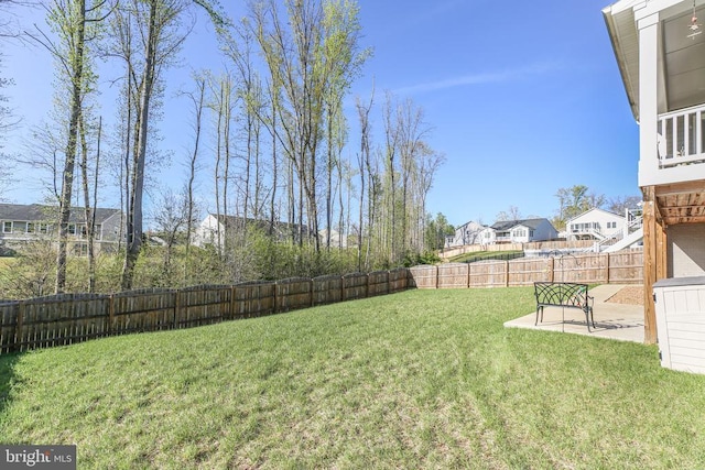 view of yard with a residential view and a patio