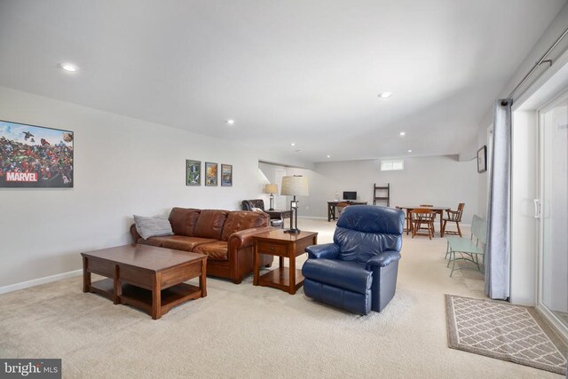 living area featuring light carpet, recessed lighting, and baseboards