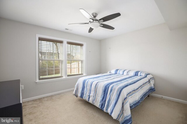 bedroom featuring baseboards, carpet, and a ceiling fan