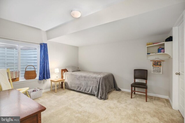 carpeted bedroom featuring baseboards