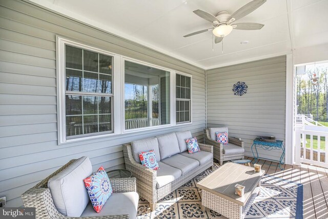 sunroom / solarium with ceiling fan and an outdoor hangout area