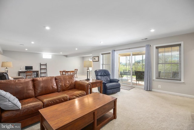living area featuring recessed lighting, baseboards, and light colored carpet