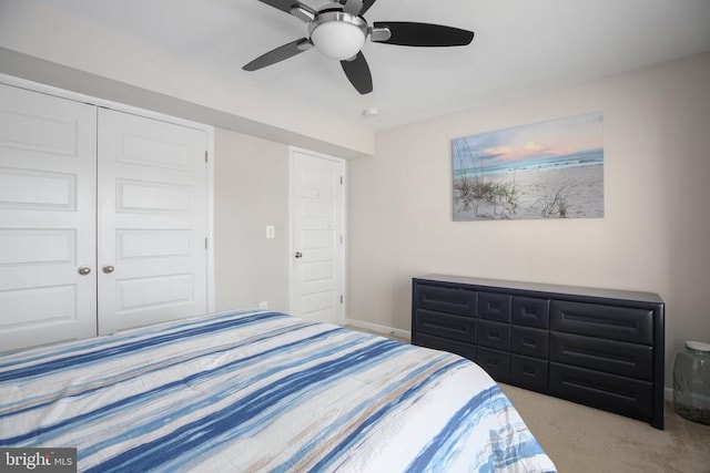 carpeted bedroom with a closet and ceiling fan