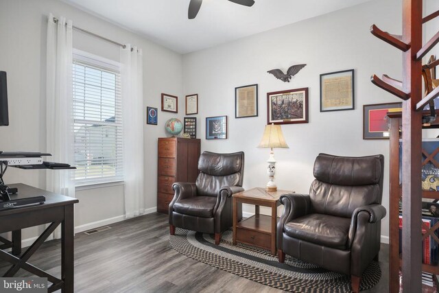sitting room with healthy amount of natural light, a ceiling fan, wood finished floors, and baseboards