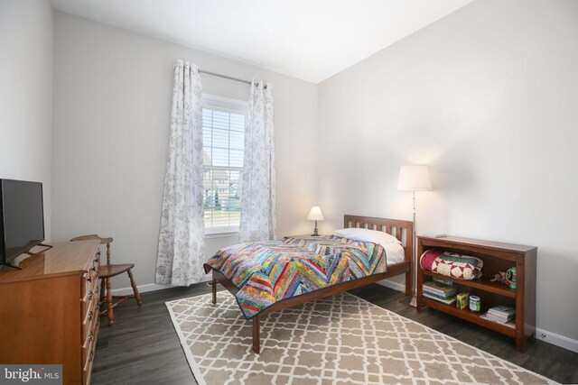 bedroom featuring wood finished floors and baseboards