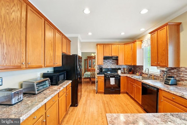 230 Whitworth Dr, Culpeper, VA 22701 - kitchen with black appliances, a sink, under cabinet range hood, light wood finished floors, and ornamental molding