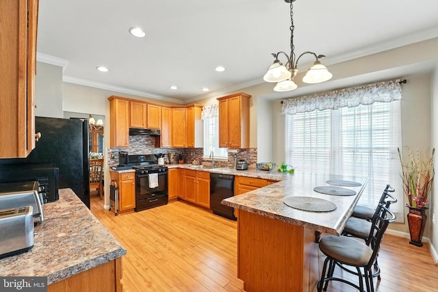 230 Whitworth Dr, Culpeper, VA 22701 - kitchen featuring black appliances, a peninsula, a sink, healthy amount of natural light, and crown molding