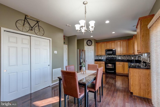 2018 Silver Bell Ct, Culpeper, VA 22701 - dining area with a chandelier, dark wood-style floors, and recessed lighting