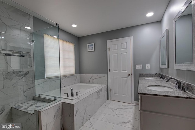2018 Silver Bell Ct, Culpeper, VA 22701 - bathroom featuring a garden tub, marble finish floors, double vanity, a marble finish shower, and recessed lighting