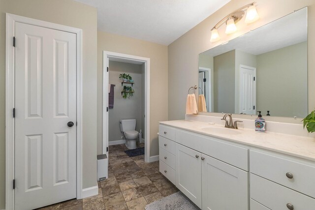 324 Rustic Ave, Broadway, VA 22815 - bathroom with vanity, baseboards, toilet, and stone finish floors