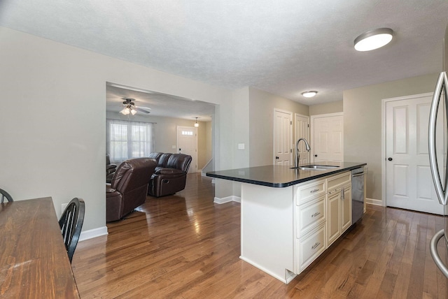 324 Rustic Ave, Broadway, VA 22815 - kitchen with a sink, dark countertops, stainless steel appliances, wood finished floors, and baseboards