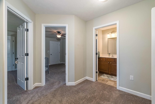 324 Rustic Ave, Broadway, VA 22815 - corridor featuring light colored carpet, baseboards, and a sink