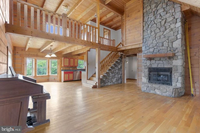 6403 Zachary Taylor Hwy, Culpeper, VA 22701 - unfurnished living room featuring high vaulted ceiling, light wood-style floors, wood ceiling, a fireplace, and beam ceiling