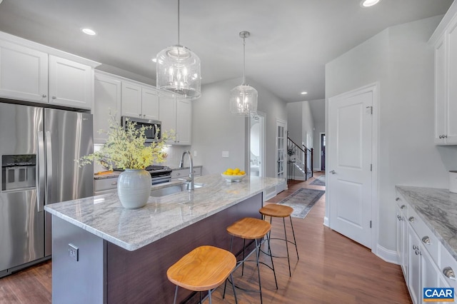 kitchen with white cabinetry, stainless steel appliances, dark wood-style flooring, and a sink