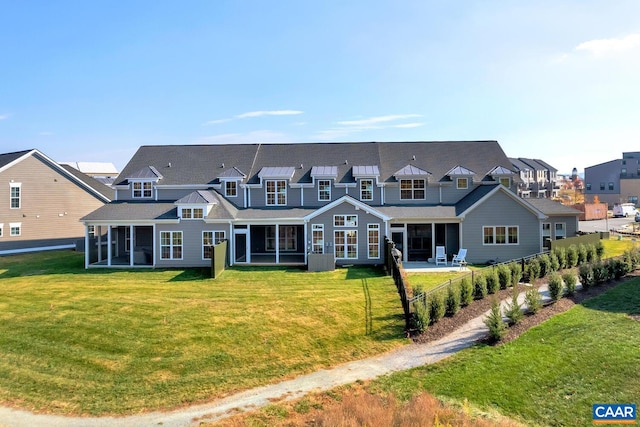 view of front facade with a sunroom, a front yard, fence, and a residential view