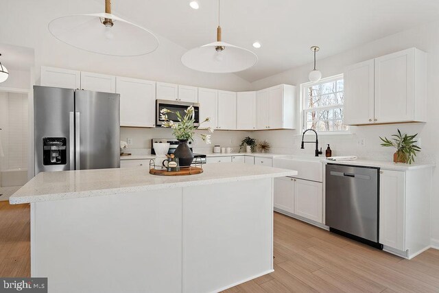 6000 Bills Rd, Mineral, VA 23117 - kitchen featuring stainless steel appliances, white cabinetry, a sink, a kitchen island, and vaulted ceiling