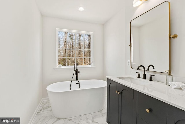 6000 Bills Rd, Mineral, VA 23117 - bathroom featuring a freestanding bath, marble look tiles, vanity, baseboards, and recessed lighting