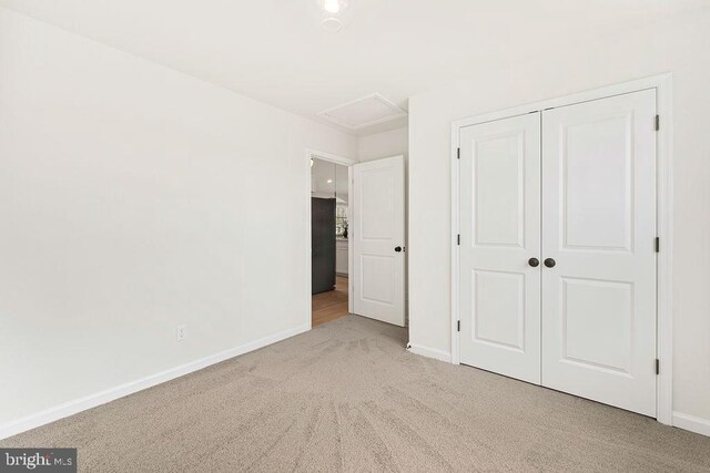 6000 Bills Rd, Mineral, VA 23117 - unfurnished bedroom with carpet, attic access, baseboards, black refrigerator, and a closet
