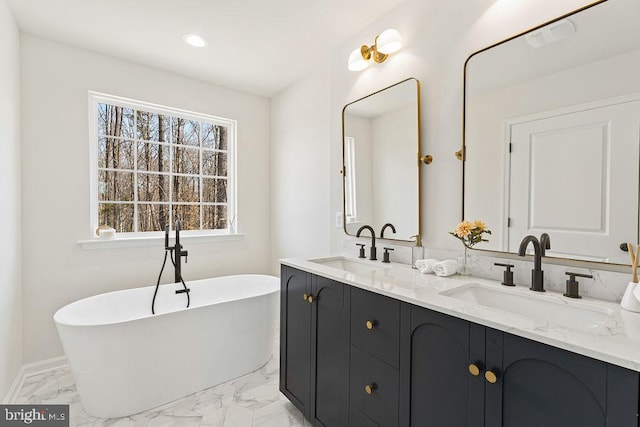 6000 Bills Rd, Mineral, VA 23117 - full bath with marble look tile flooring, a freestanding bath, double vanity, recessed lighting, and baseboards