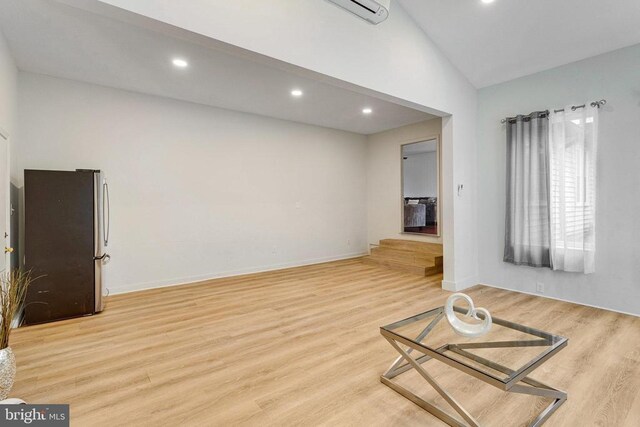 9150 James Madison Hwy, Warrenton, VA 20186 - unfurnished room with light wood-type flooring, recessed lighting, lofted ceiling, and a wall mounted AC