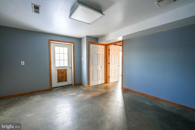 spare room with concrete floors